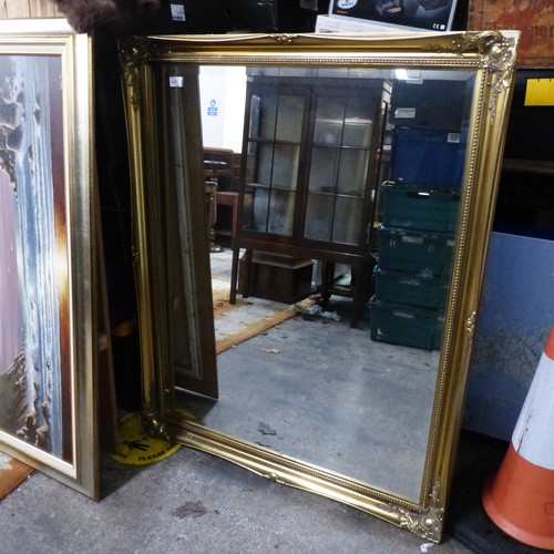 686 - Very large gilt framed and bevelled edged wall mirror. size 132cm x 106cm