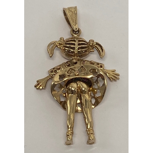 640 - 9ct gold doll pendant, set with red and white gem stones,15.2g.