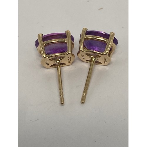 639 - Pair 9ct gold earrings set with purple stones, 2.1g.