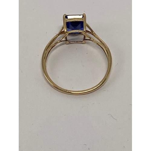 645 - 9ct gold ladies flamboyant dress ring, set with large rectangular blue stone, size R, 2g.