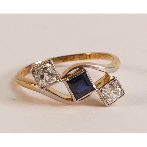 717 - 18ct Gold ring set with square cut Sapphire surrounded by two square cut Diamonds, size L, 2.3g.