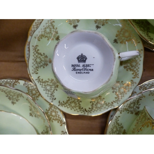 355 - Royal Albert tea set in mint green with gold highlights, milk jug, sugar bowl, cake plate and 5 trio... 