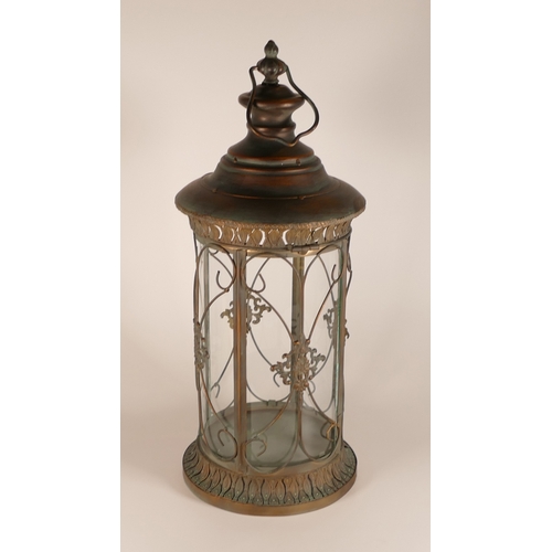 768 - Ornate metal and glass round lantern, with hinged door and carrying handle, h.57 x d.25cm.