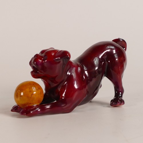 64 - Bernard Moore Flambe model of a dog playing with a yellow ball, L.11 x h.5.25cm.