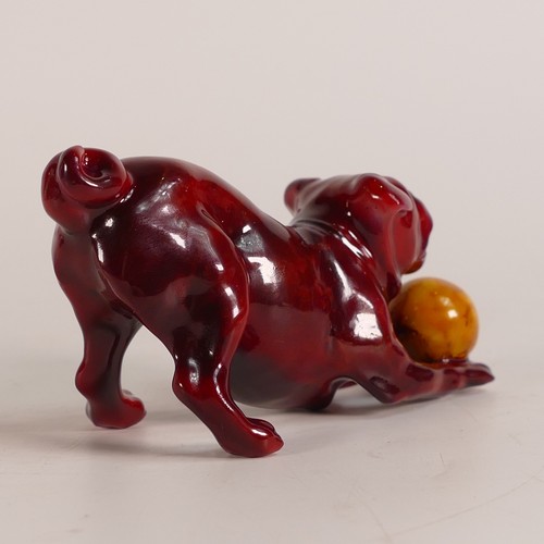 64 - Bernard Moore Flambe model of a dog playing with a yellow ball, L.11 x h.5.25cm.