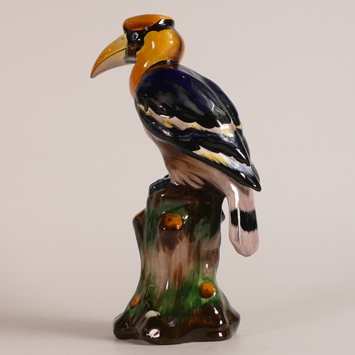 65 - Tuscan China model of a Toucan perched on a tree stump, multicoloured, h.24cm.