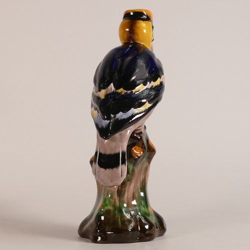 65 - Tuscan China model of a Toucan perched on a tree stump, multicoloured, h.24cm.