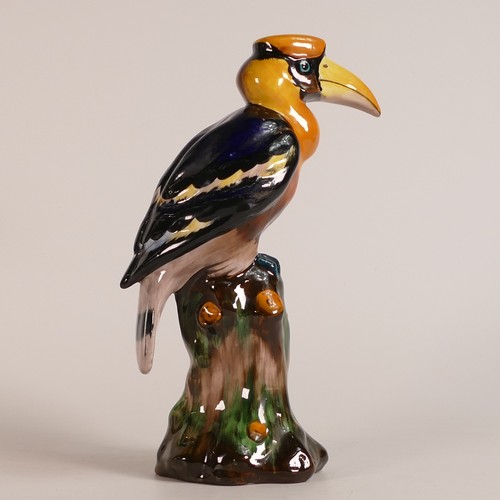 65 - Tuscan China model of a Toucan perched on a tree stump, multicoloured, h.24cm.