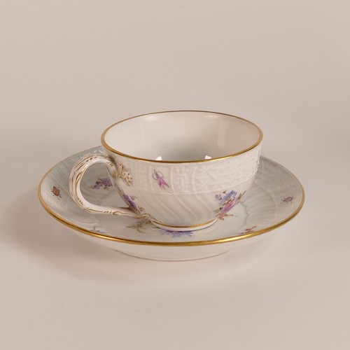 103 - Meissen, porcelain tea cup and saucer. Painted with floral and insect motifs on blanc white moulded ... 