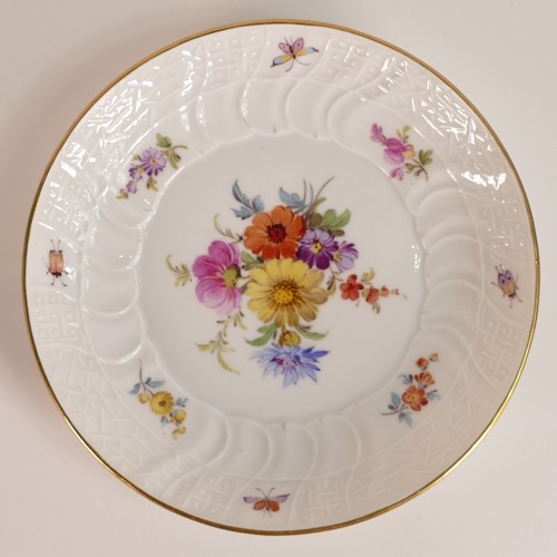 103 - Meissen, porcelain tea cup and saucer. Painted with floral and insect motifs on blanc white moulded ... 