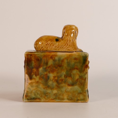 107 - 19th century Staffordshire Majolica money bank. Modelled as a mantlepiece with reclining dog above a... 