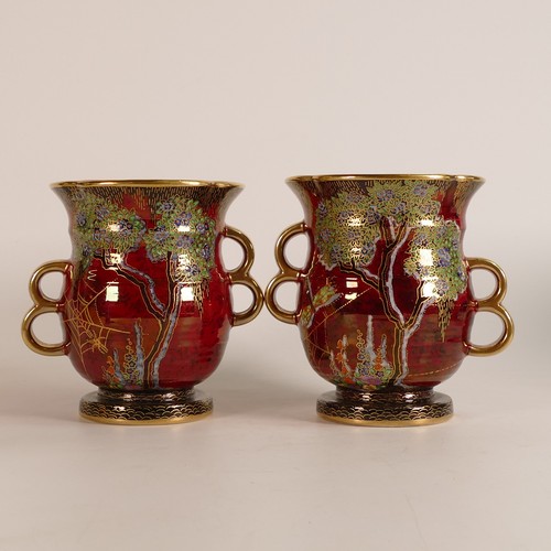 114 - Crown Devon, three red lustre vases to include a pair of garden scene loop handled examples and a la... 