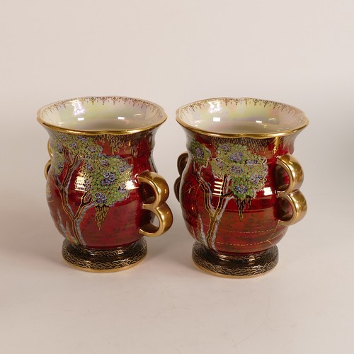 114 - Crown Devon, three red lustre vases to include a pair of garden scene loop handled examples and a la... 