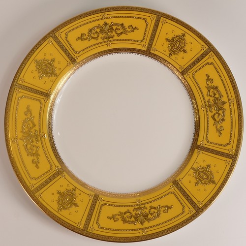 235 - Minton, two heavily gilt dinner plates. Heavily gilt with cream and yellow ground panels with elabor... 