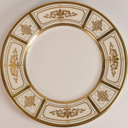 235 - Minton, two heavily gilt dinner plates. Heavily gilt with cream and yellow ground panels with elabor... 