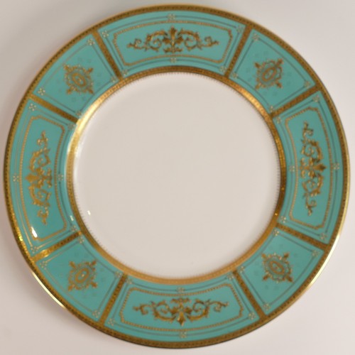 236 - Minton, two heavily gilt dinner plates. Heavily gilt with light blue and red ground panels with elab... 