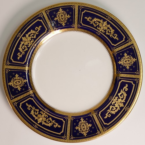 240 - Minton, six heavily gilt plates. One 23cm heavily gilt with Cobalt ground border and elaborate raise... 