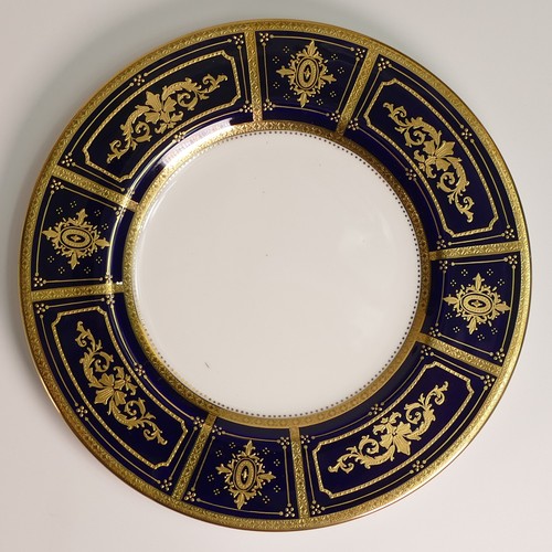 240 - Minton, six heavily gilt plates. One 23cm heavily gilt with Cobalt ground border and elaborate raise... 