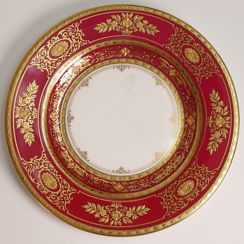 241 - Minton, seven heavily gilt plates. In red and light blue grounds with elaborate raised gilt patterns... 