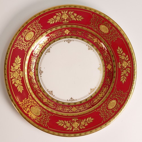 241 - Minton, seven heavily gilt plates. In red and light blue grounds with elaborate raised gilt patterns... 