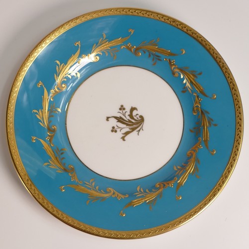 241 - Minton, seven heavily gilt plates. In red and light blue grounds with elaborate raised gilt patterns... 