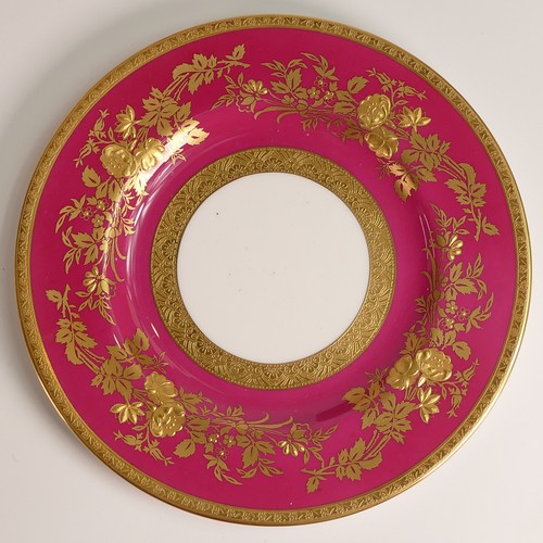 241 - Minton, seven heavily gilt plates. In red and light blue grounds with elaborate raised gilt patterns... 