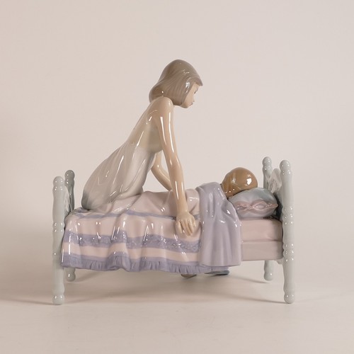 265 - Lladro, Sleep Tight modelled as a mother putting her daughter to bed. Height: 20cm. Boxed.