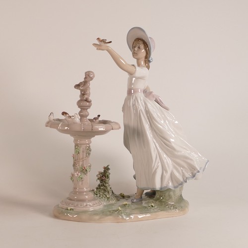 266 - Lladro, large figure Spring Joy modelled as a girl at a bird bath. Height: 28cm.