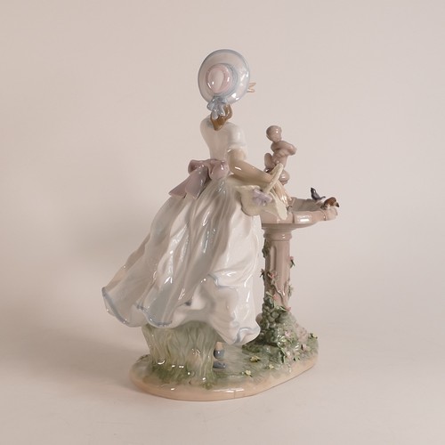 266 - Lladro, large figure Spring Joy modelled as a girl at a bird bath. Height: 28cm.