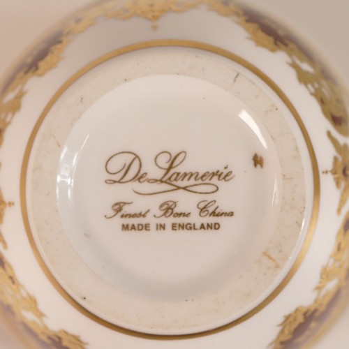 291 - De Lamerie Fine Bone China, sixteen Burgundy Majestic pattern porcelain tea bowls. (16)