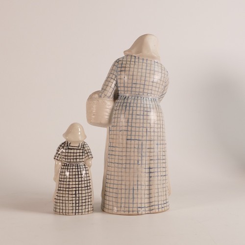 416 - Royal Doulton, two Stoneware figures of the 'Dutch Woman'. Designed by Leslie Harradine. One large i... 