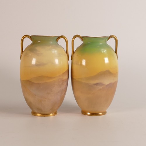 525 - J. A. Phillips for Royal Doulton, pair of hand painted twin handled vases. Painted with highland sta... 