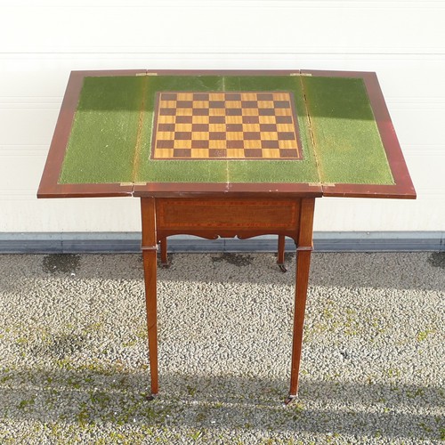 802 - Edwardian inlaid Mahogany fold over games table. Pull out pegboard and table supports. Shaped apron ... 