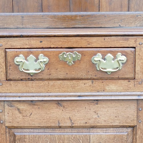 826 - Georgian large Oak dresser. Of panel construction with three upper drawers over two lower cupboards.... 