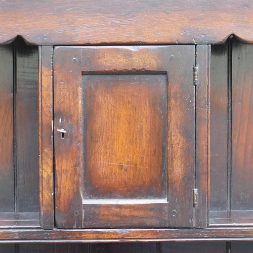 827 - Georgian Oak Dresser. Upper section with shaped frieze and one central locking cupboard to upper she... 