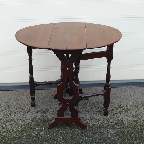 829 - 18th century gate leg Oak table. Of oval drop leaf form with Lyre shaped columns and turned wood gat... 