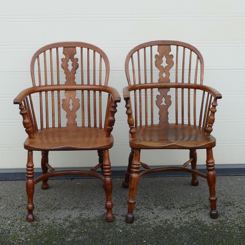 832 - Four 19th century Elm and Yew Windsor armchairs. Shaped splat, integral bow arms, with stick backs a... 