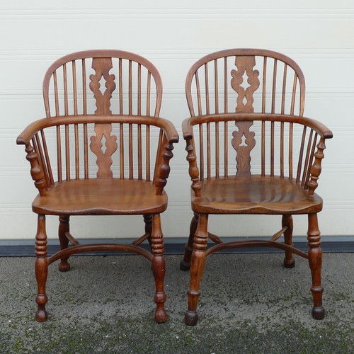 832 - Four 19th century Elm and Yew Windsor armchairs. Shaped splat, integral bow arms, with stick backs a... 