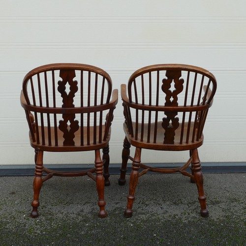 832 - Four 19th century Elm and Yew Windsor armchairs. Shaped splat, integral bow arms, with stick backs a... 