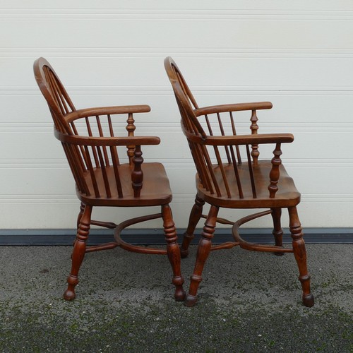 832 - Four 19th century Elm and Yew Windsor armchairs. Shaped splat, integral bow arms, with stick backs a... 