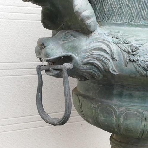 842 - 20th century Bronze garden Urn, cast with twin cherubs facing inwards and loop handles held by lions... 