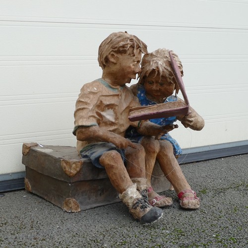 906 - Phillip Cox (English, b.1945-) A card and Papiermâché sculpture of two children reading Pinocchio sa... 