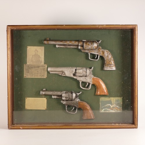 1069 - Franklin Mint, mounted reproduction Doc Holliday .45 Revolver together with framed trio of simulatio... 