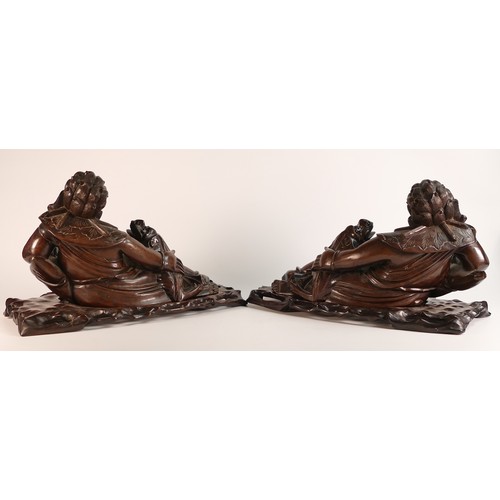 1085 - Two carved wooden figures depicting Liu Haichan reclining with mythical dragon besides.  Length: app... 