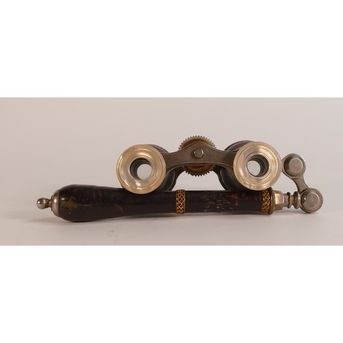 1122 - A pair of late Victorian Opera glasses. Gilt tooled leather handle and barrel with mother of pearl a... 