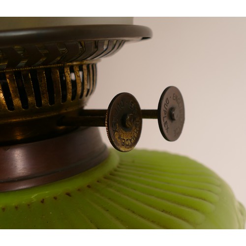 1125 - Late 19th century Oil lamp. Base is of mottled earthenware with brass twist shaft below a lime milk ... 