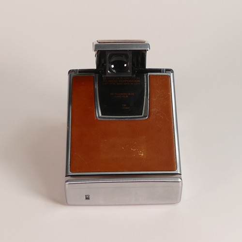 1154 - Polaroid SX-70 Land Camera. Chrome and tan covering. Includes original inserts. In Keystone leather ... 