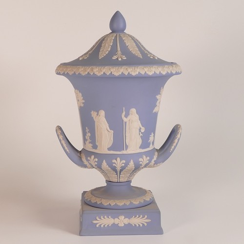 1386 - Wedgwood, blue Jasperware twin handled lidded urn. Height: 29.5cm