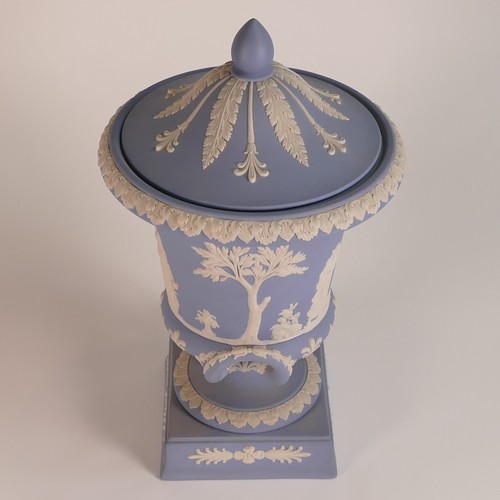 1386 - Wedgwood, blue Jasperware twin handled lidded urn. Height: 29.5cm