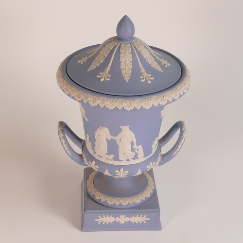 1386 - Wedgwood, blue Jasperware twin handled lidded urn. Height: 29.5cm